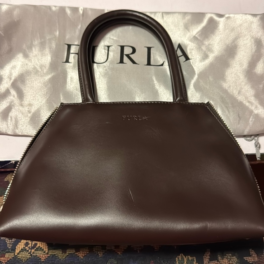 Pre-loved Furla triangular shaped bag from Europe, measures 9.5 x 6 x 4”.